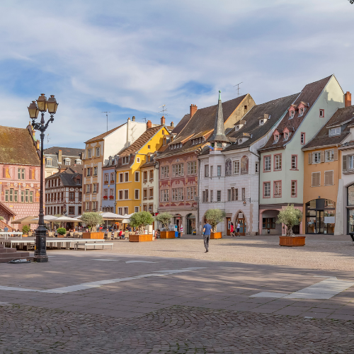 Place animée avec bâtiments colorés.
